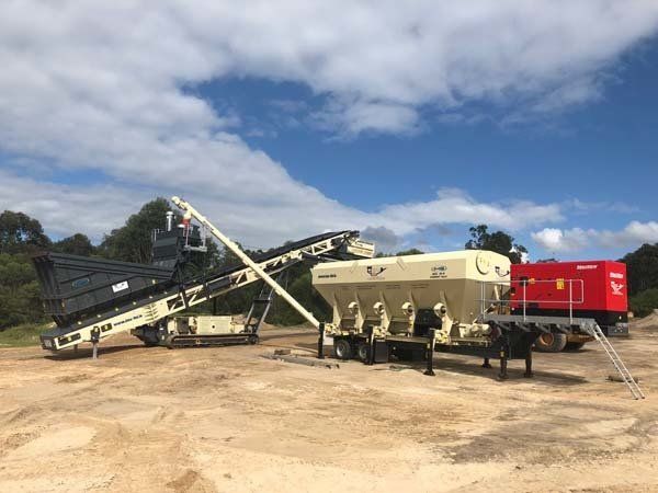 mobile cement silo being filled by track pugmill