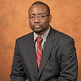 A man in a suit and tie is posing for a picture.