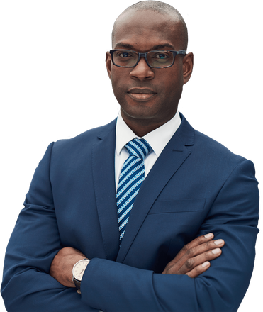 A man in a suit and tie is standing with his arms crossed.