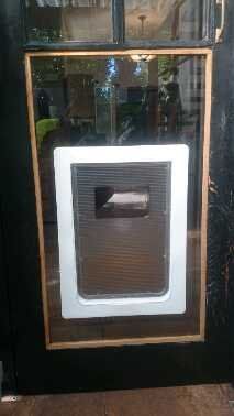 pet door in glass on black door