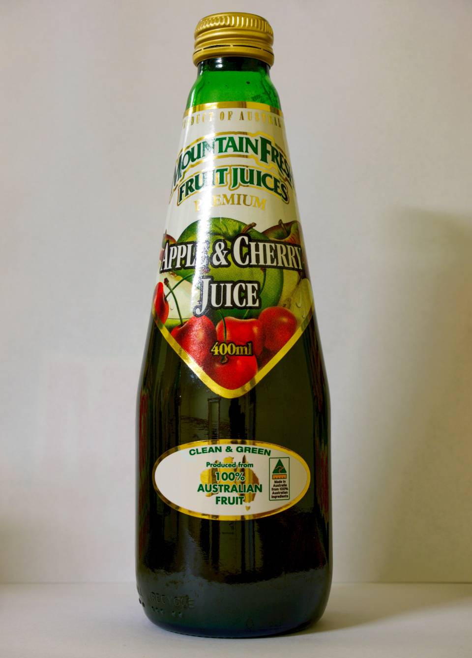 Bottle of brown juice with green and white label, labeled “Grapes & Cherry Juice.”