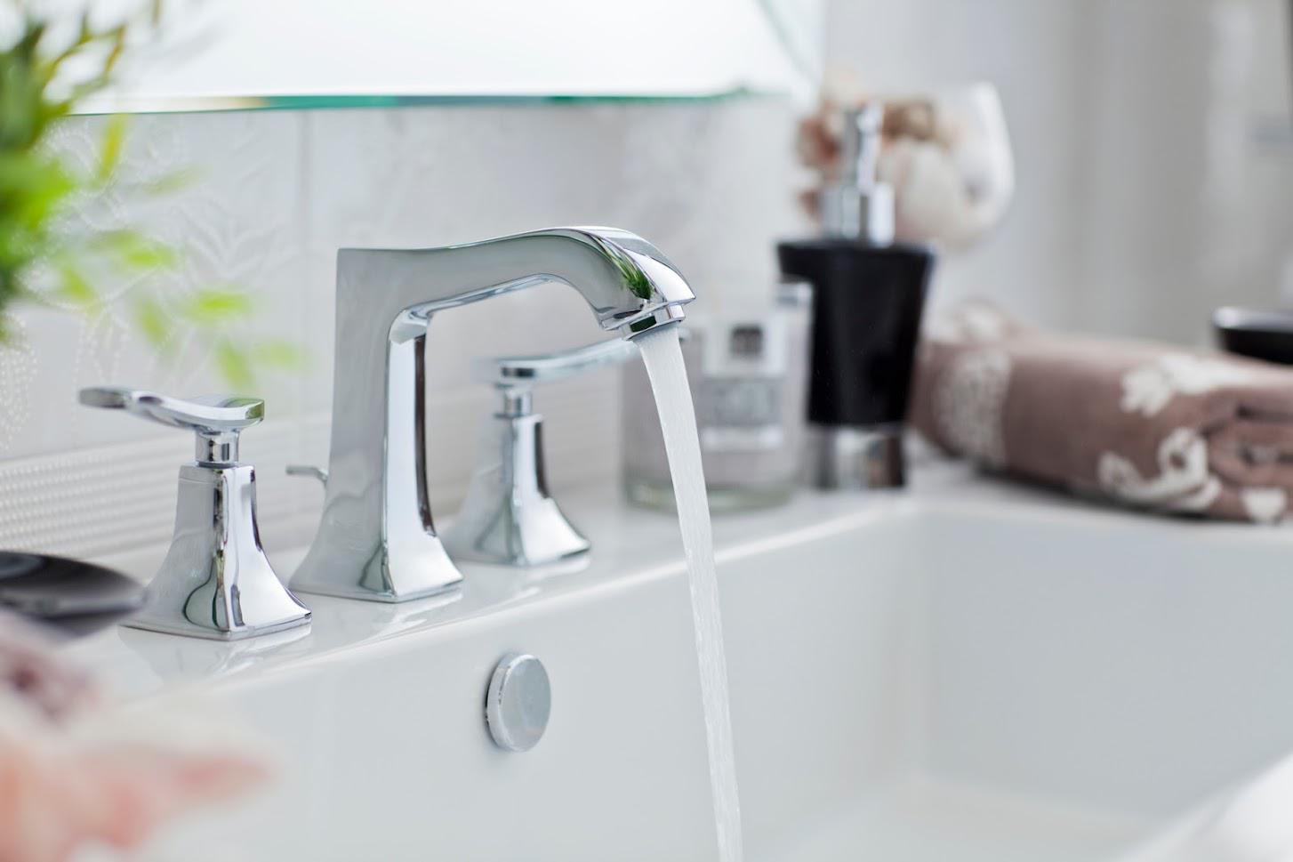 A bathroom sink with water running from a faucet.