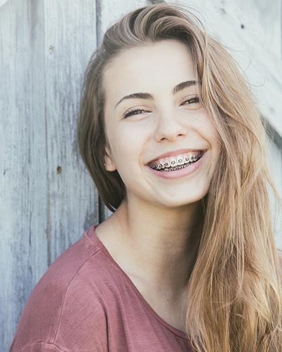 Adult Braces — Smiling Girl with Braces in Waterloo, IA Adult Braces — Smiling Girl with Braces in Waterloo, IA