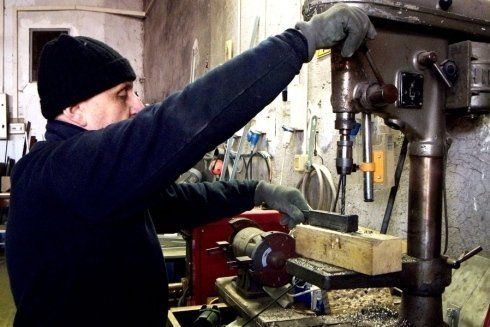 Operaio con un macchinario per la produzione di avvolgibili
