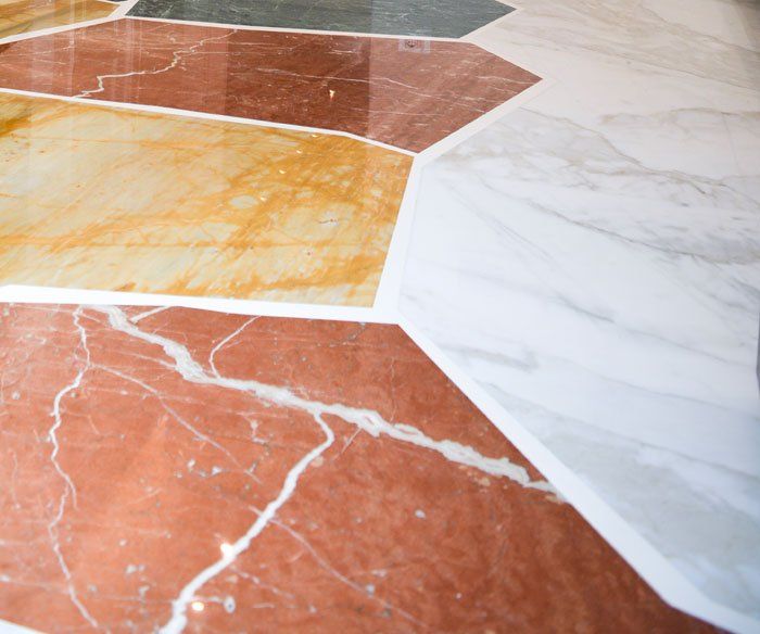 Un primo piano di un pavimento in marmo con piastrelle di diversi colori