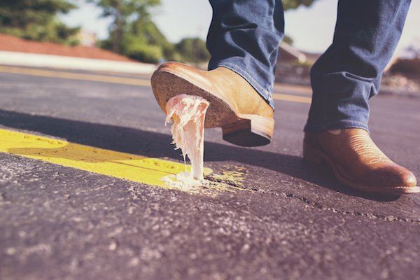 A man with gum stuck to the bottom of his shoe.