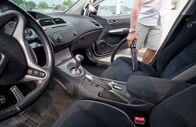 car interior being vacuumed