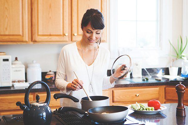 Woman cooking in kitchen.
