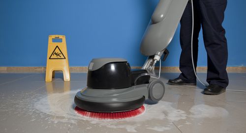 Professional commercial cleaning team member polishing a floor in Honolulu, HI