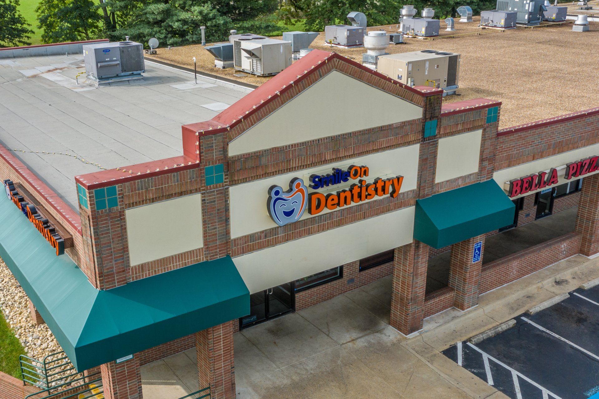 An aerial view of a dental office with green awnings