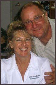 A man and a woman are posing for a picture together and smiling. A man and a woman are posing for a picture together and smiling.