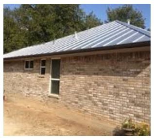 Hail Damage Roofing — Roof of Brick House in San Antonio, TX