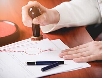 Woman Notary Public Stamping the Contract — Notary Public in Oxnard, CA Woman Notary Public Stamping the Contract — Notary Public in Oxnard, CA