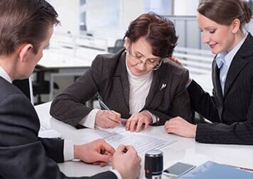 Elderly Woman Signing a Document — Notary Public in Oxnard, CA