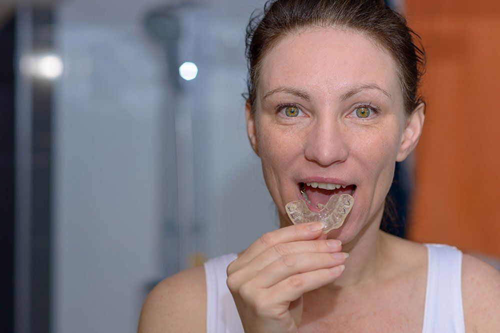 woman putting in dental nightguard