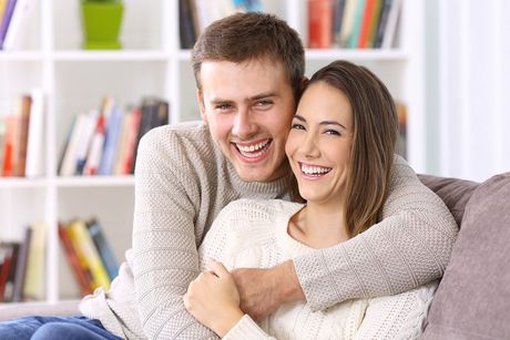 young couple together smiling