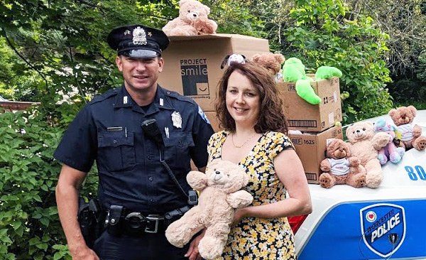 Woman and police officer with donations