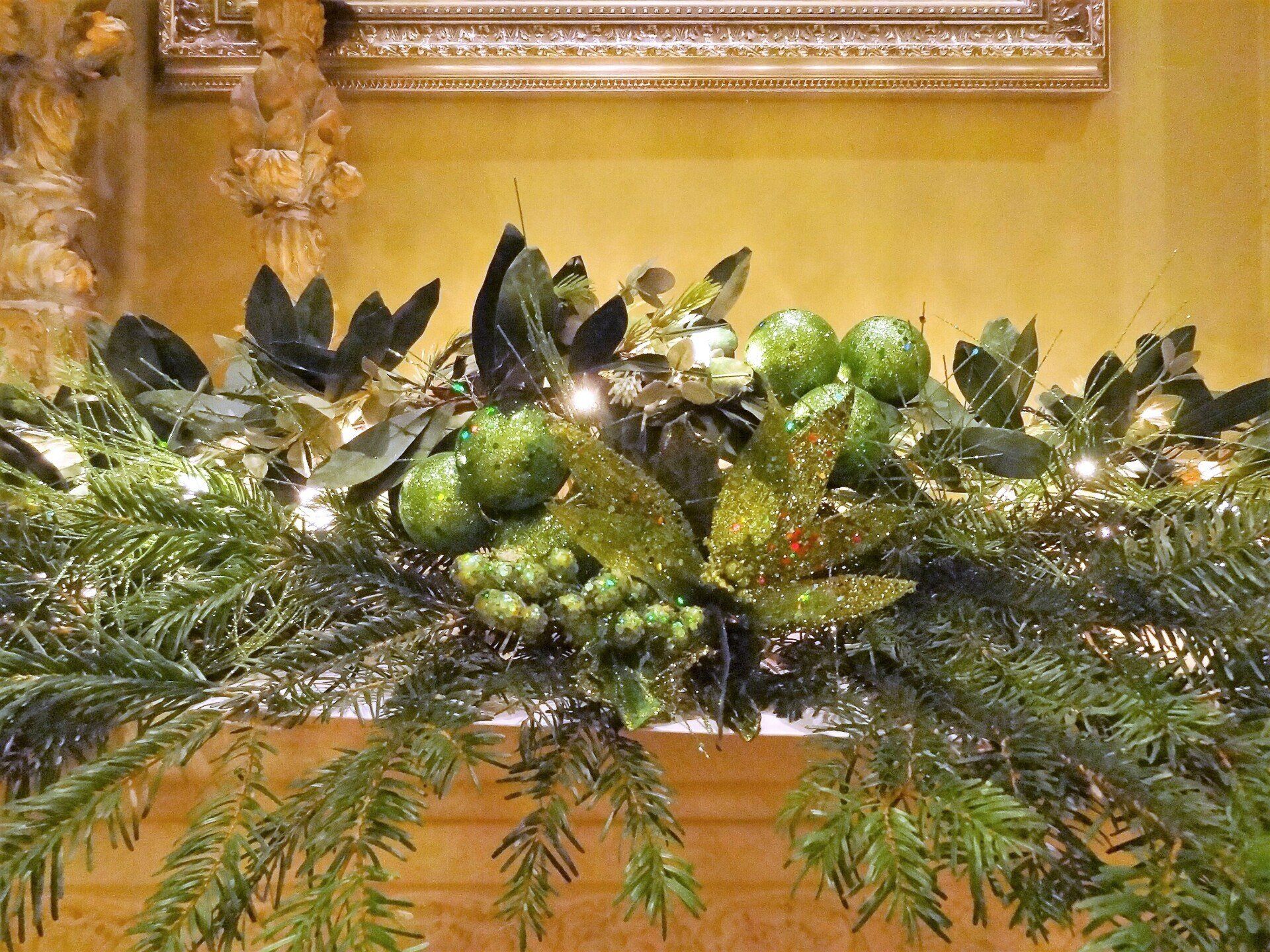 Christmas garland with green ornaments and greenery.