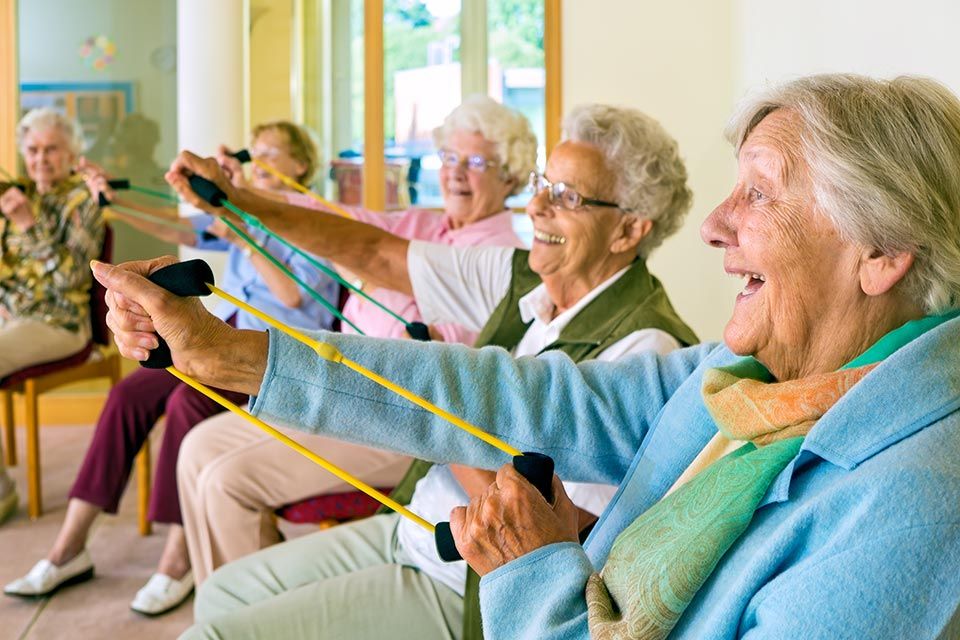 old women stretching rubber