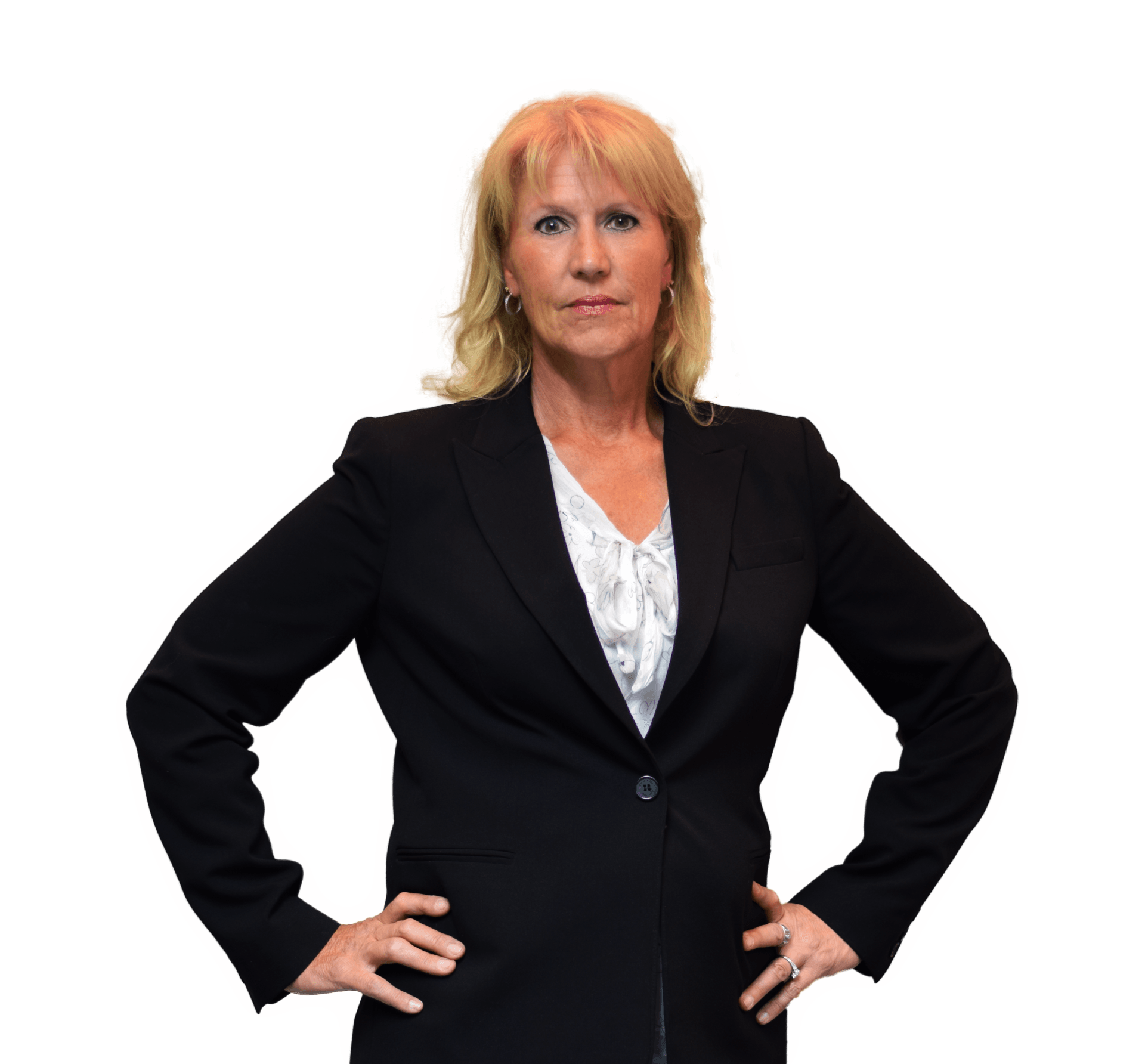 Woman in a black blazer standing with hands on hips against a white background