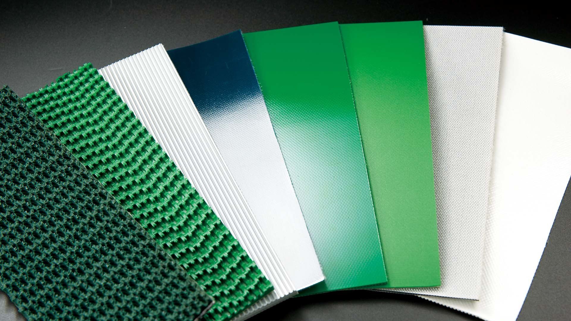 Muestras de cintas transportadoras industriales de varios colores exhibidas una al lado de la otra
