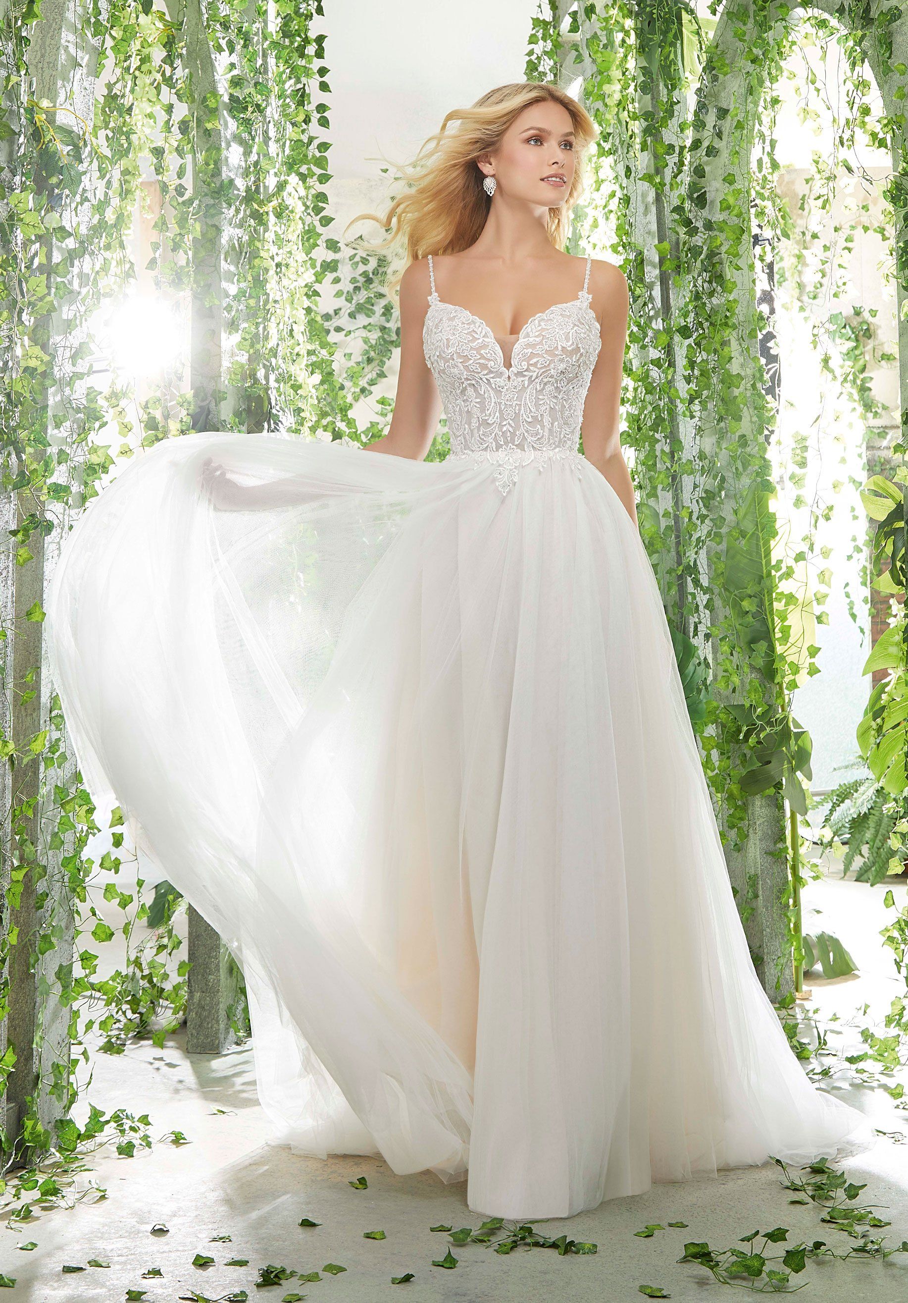 Eine Frau in einem weißen Brautkleid steht in einem Wald.