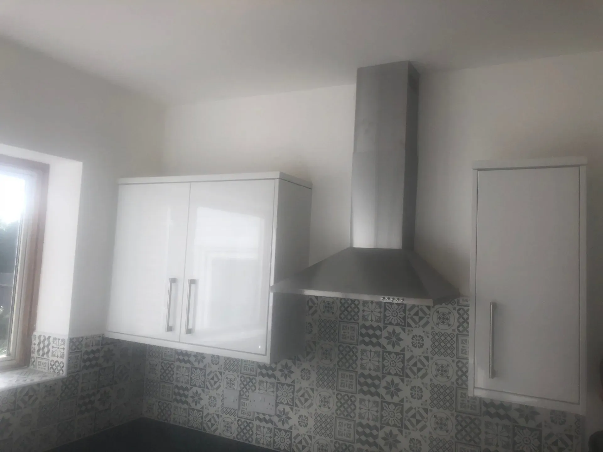 Extractor fan installation and tiled kitchen walls