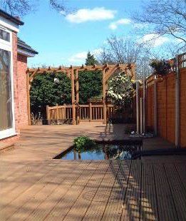 outdoor decking installation with pond