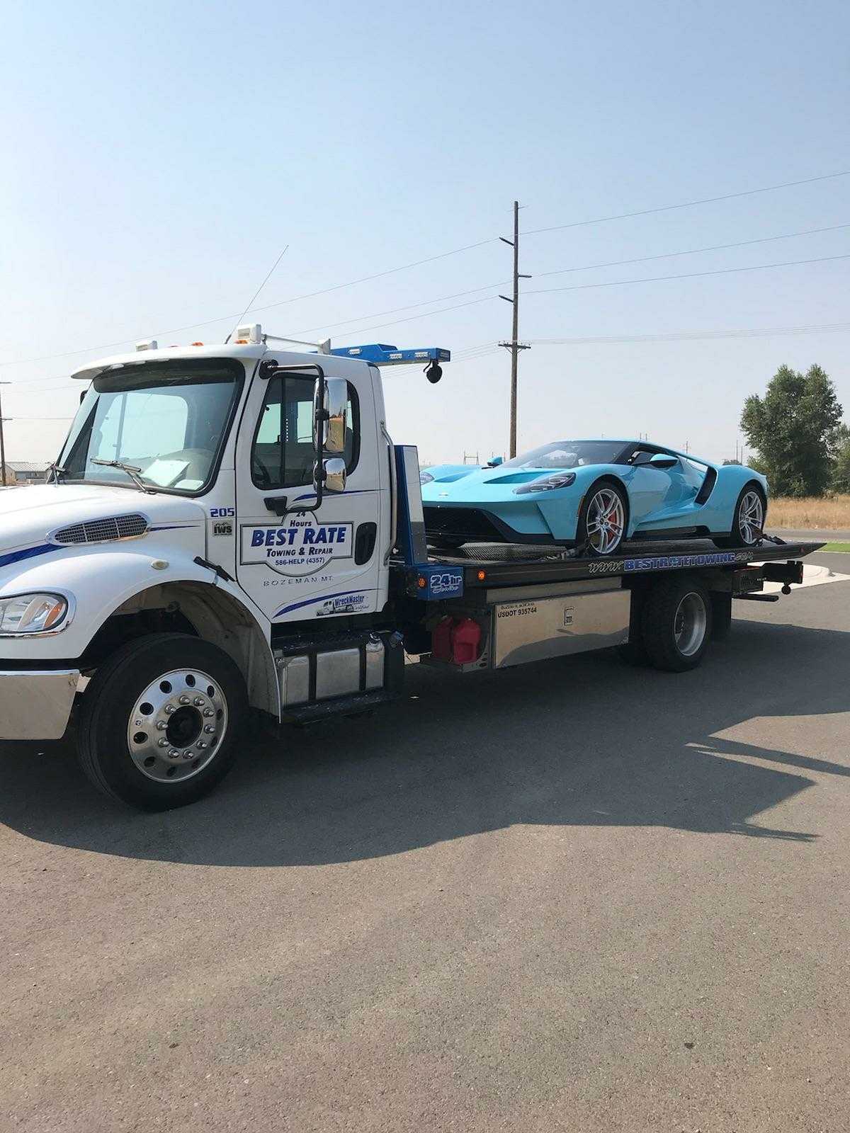 24/7 Towing — Tow Truck Delivering Car in Gallatin County, MT 24/7 Towing — Tow Truck Delivering Car in Gallatin County, MT