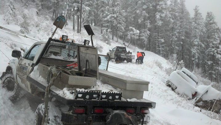 Emergency Tow Truck — Light Tow Truck On Snow in Gallatin County, MT Emergency Tow Truck — Light Tow Truck On Snow in Gallatin County, MT