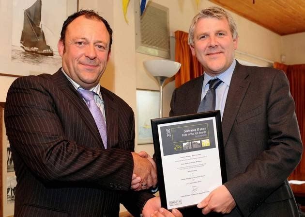 receiving an award on behalf of project eleven