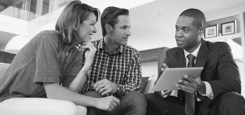 Financial consultant presents bank investments to a young couple