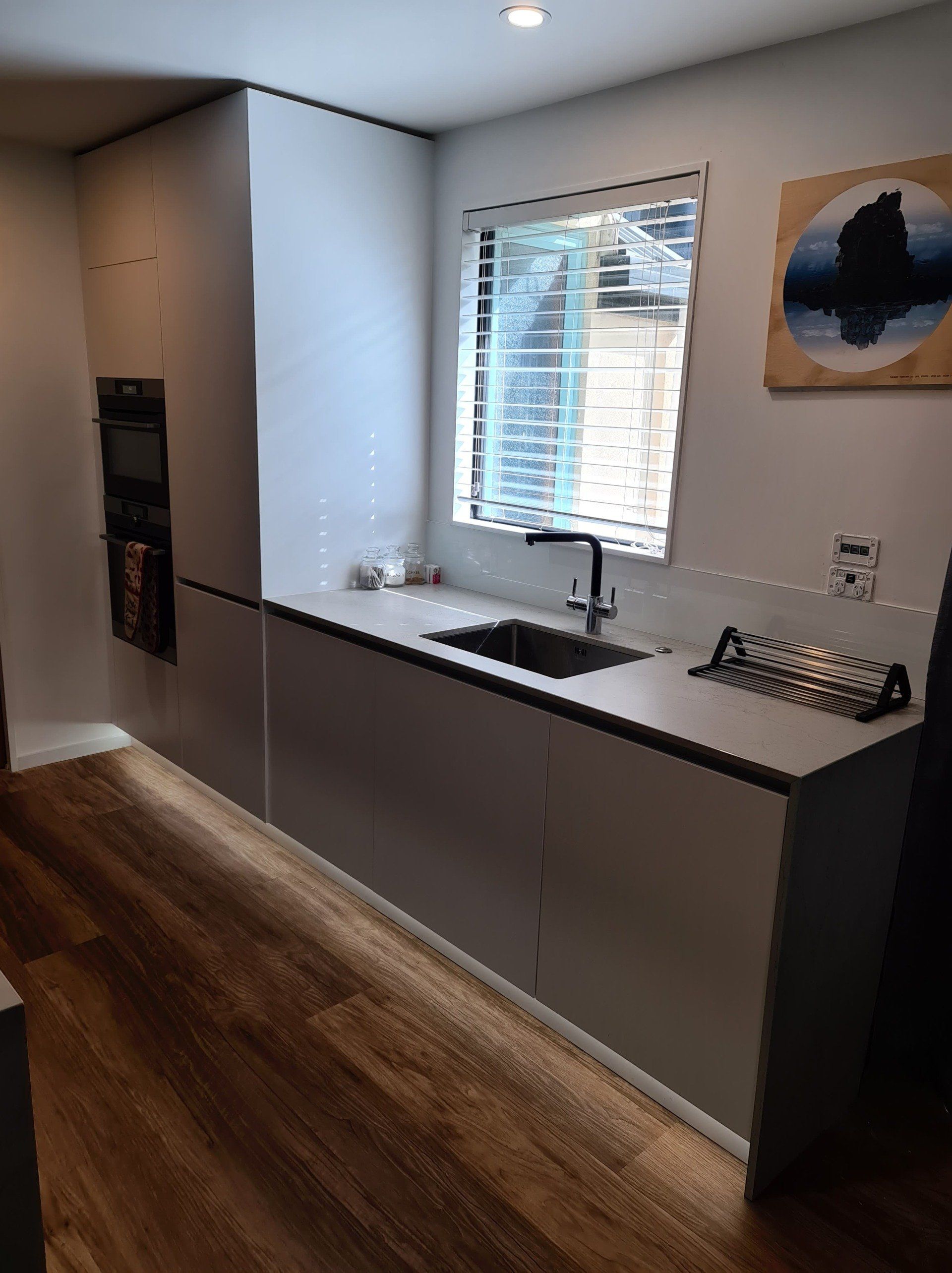 A kitchen with a sink and a window.