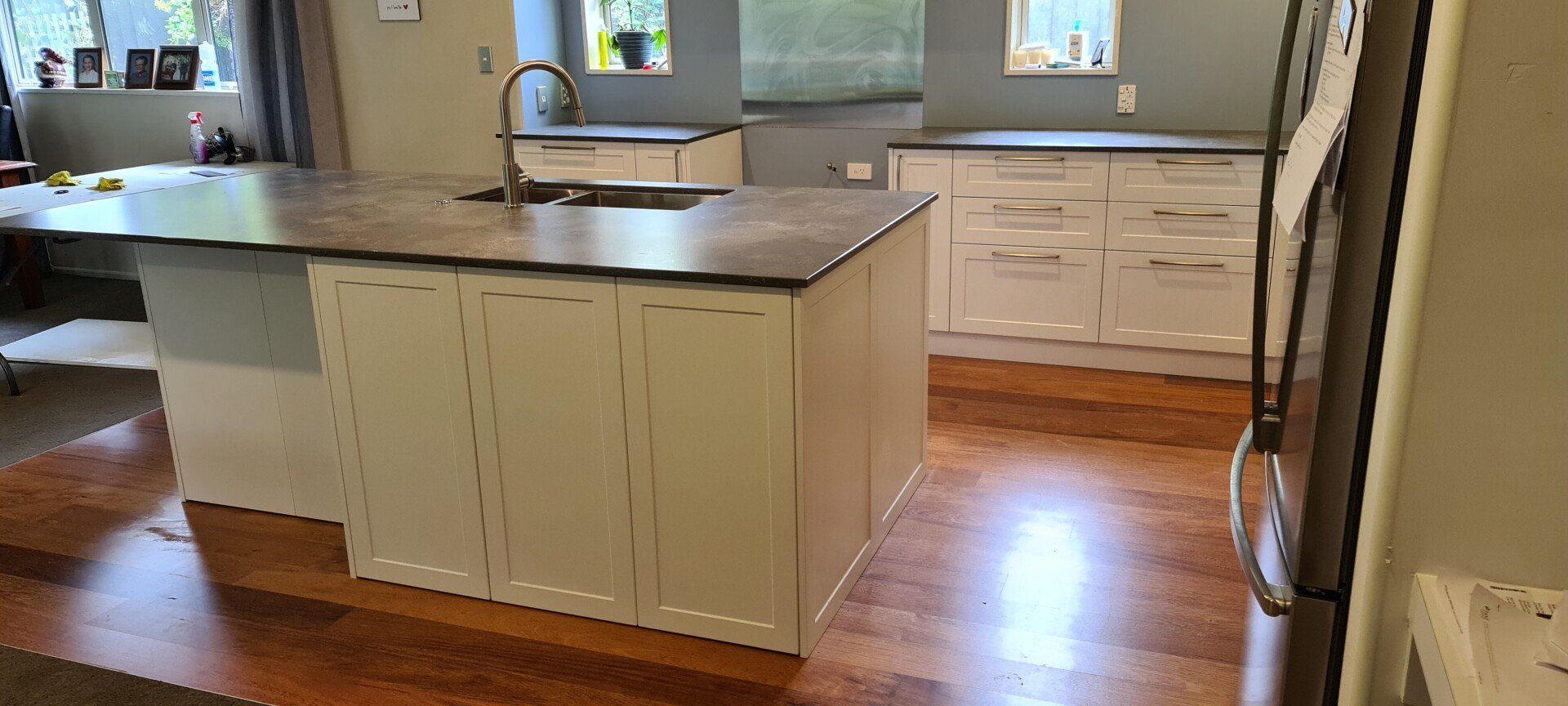 A kitchen with a large island and a sink.