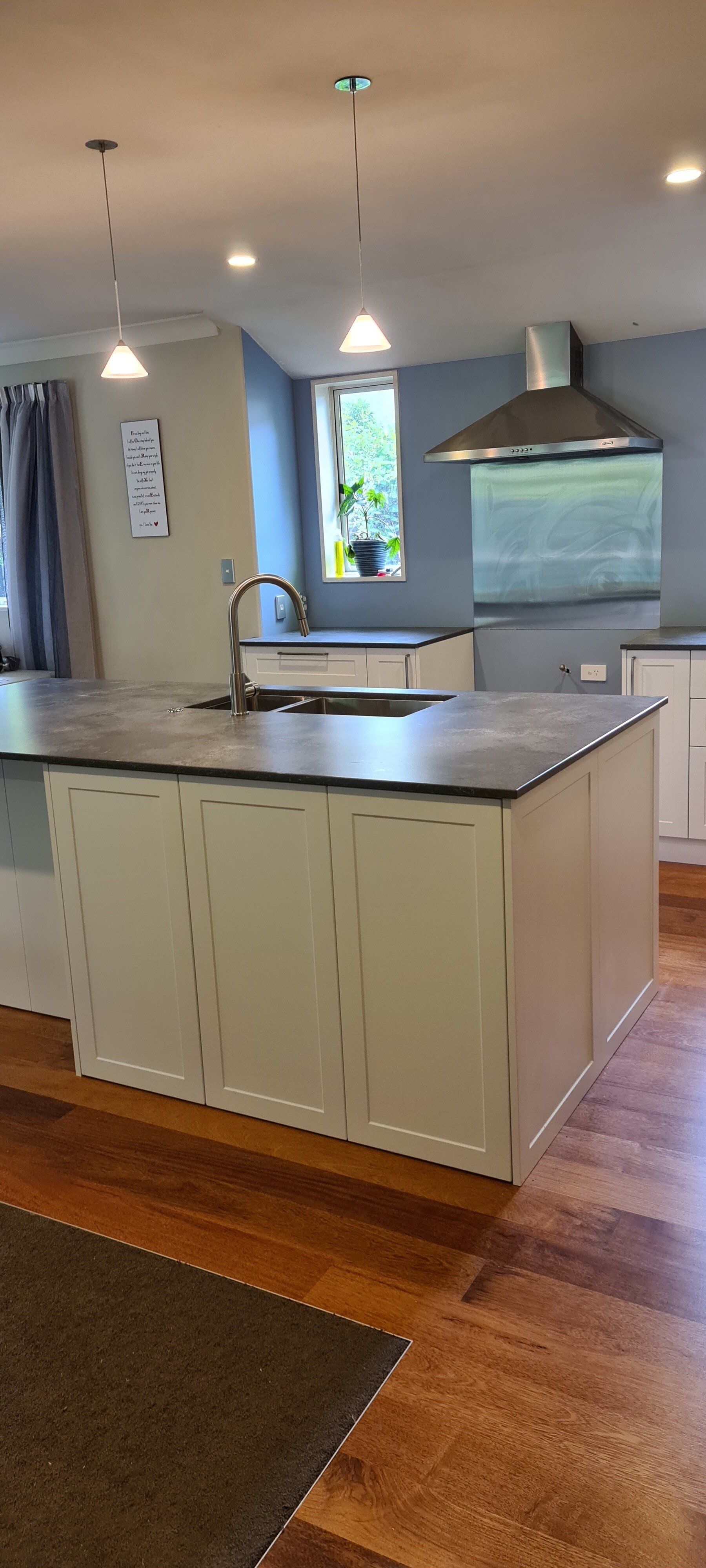 A kitchen with a large island and a sink.