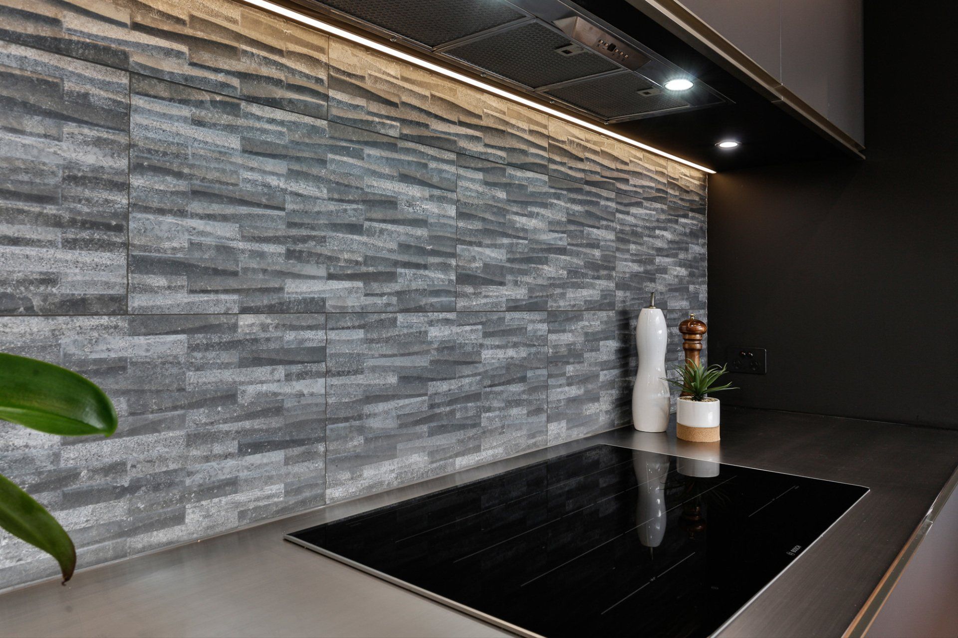 A kitchen with a stove top oven and a stainless steel counter top.