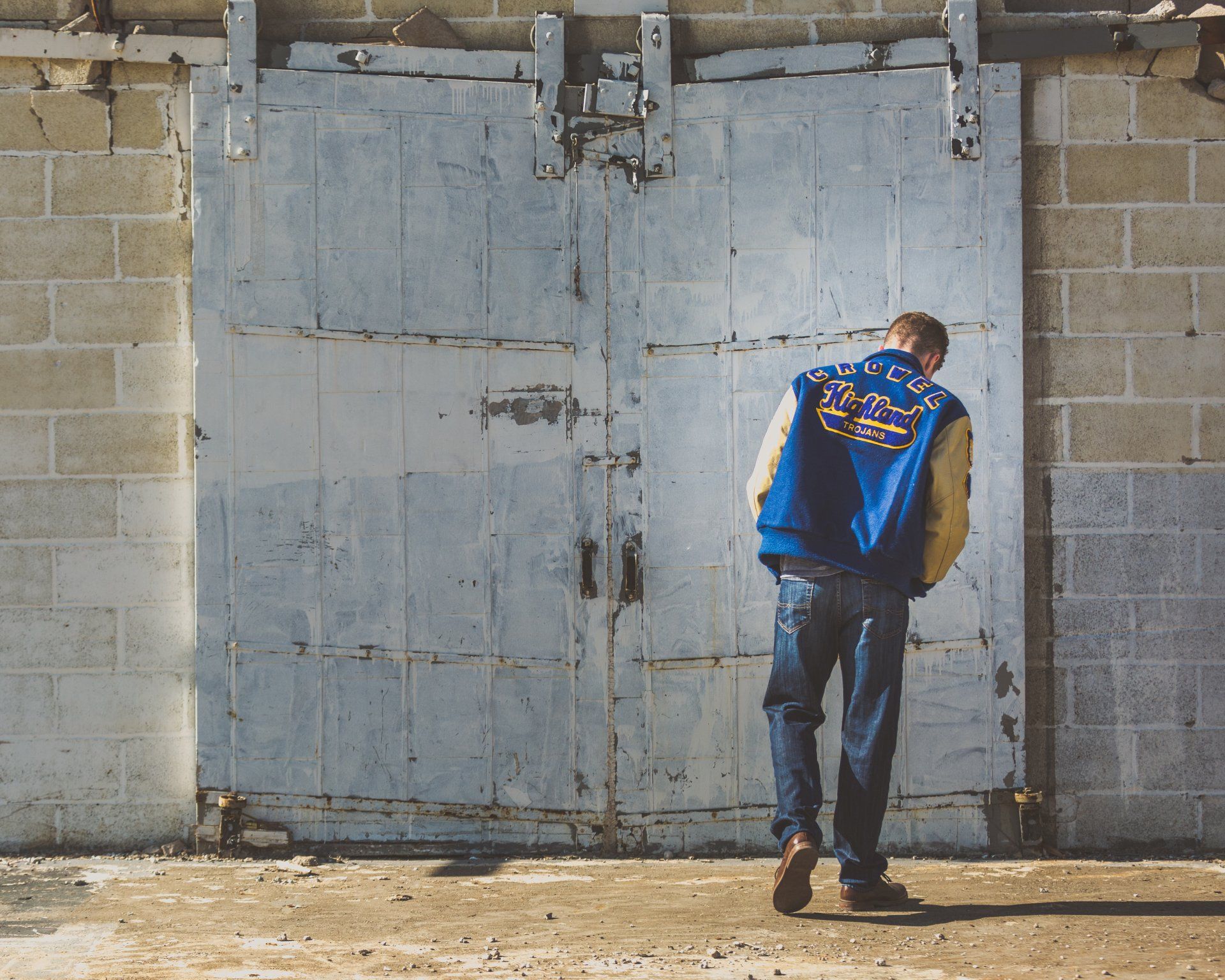 A man wearing a blue and yellow jacket with the word eagles on it