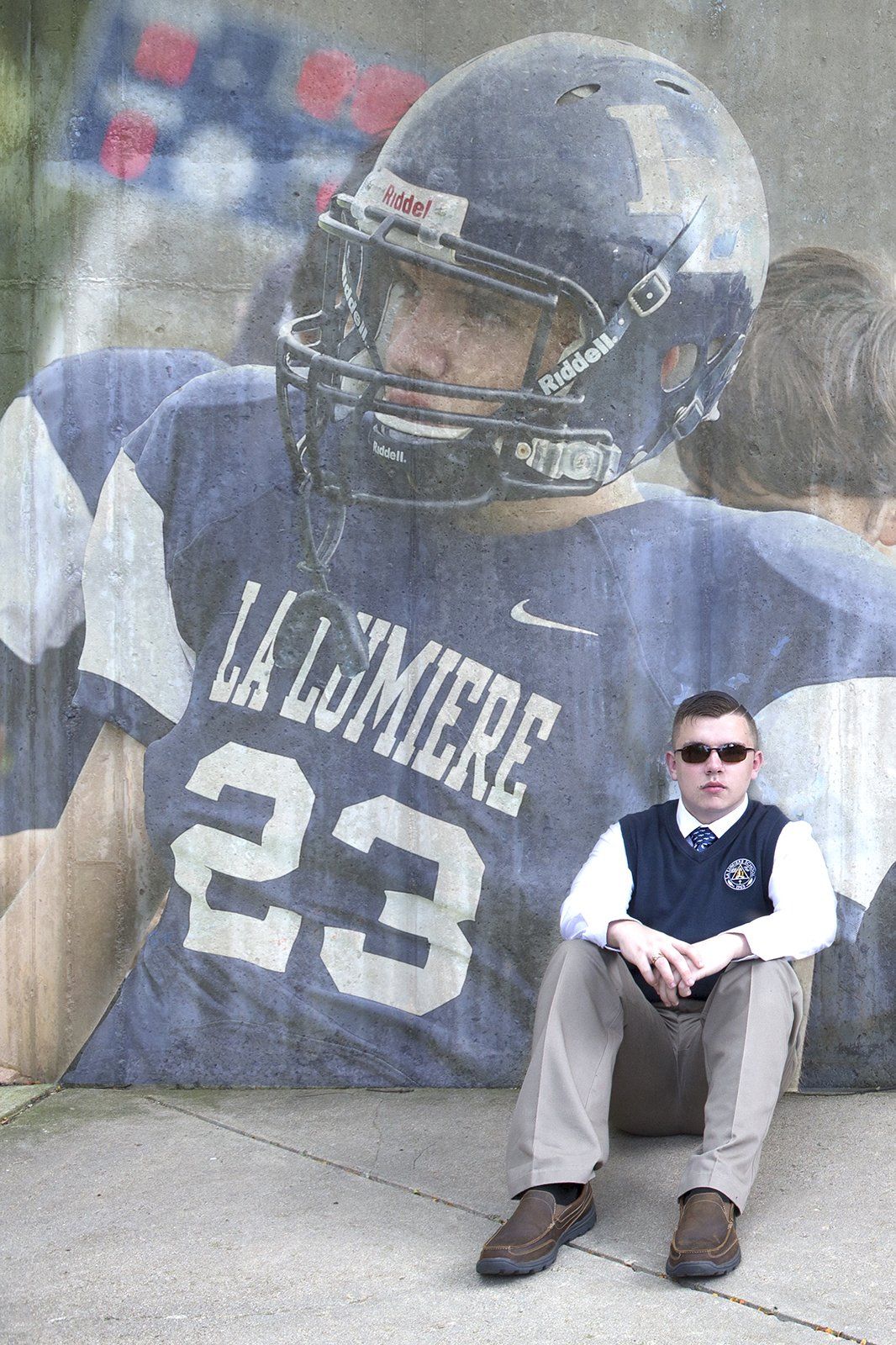 A man is sitting in front of a football player with the number 23 on his jersey