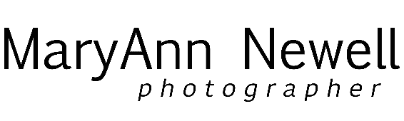A black and white logo for mary ann newell photographer