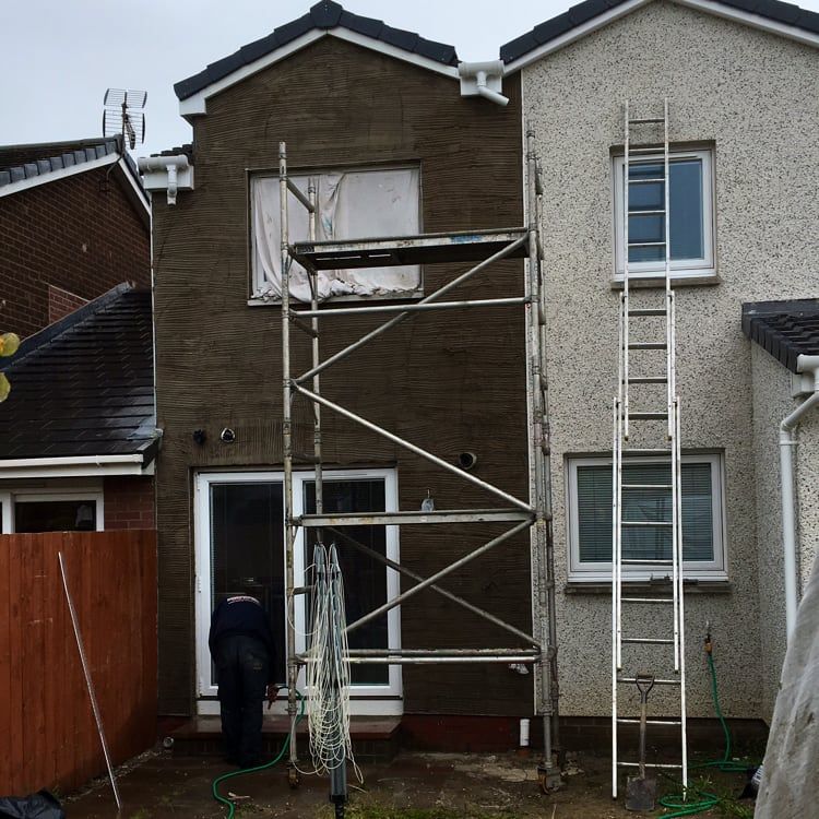 Scaffolding set up outside two adjoining homes
