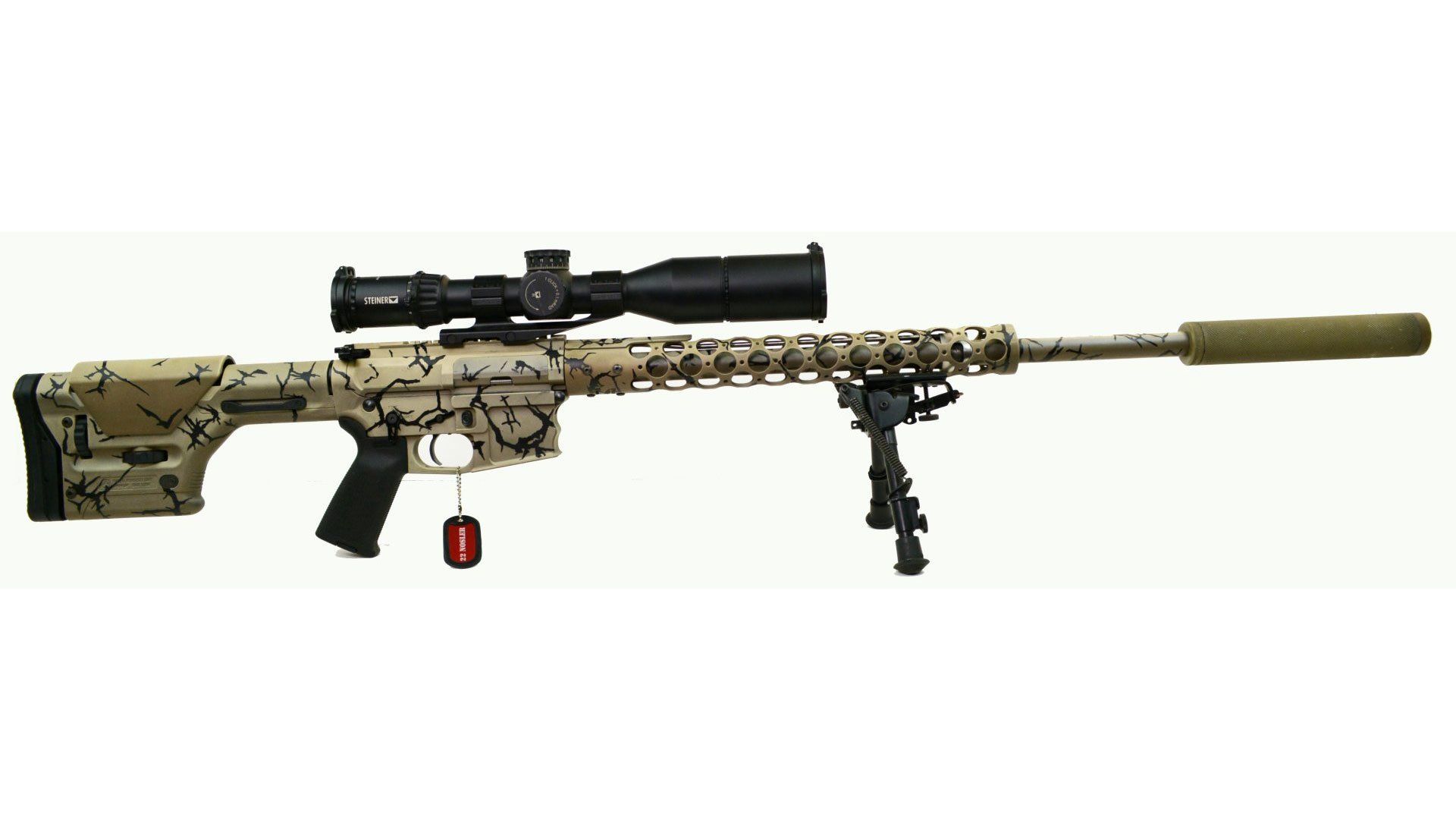 Camouflaged sniper rifle with scope and suppressor.