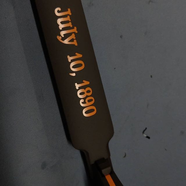 Black object with gold lettering: July 10, 1890.