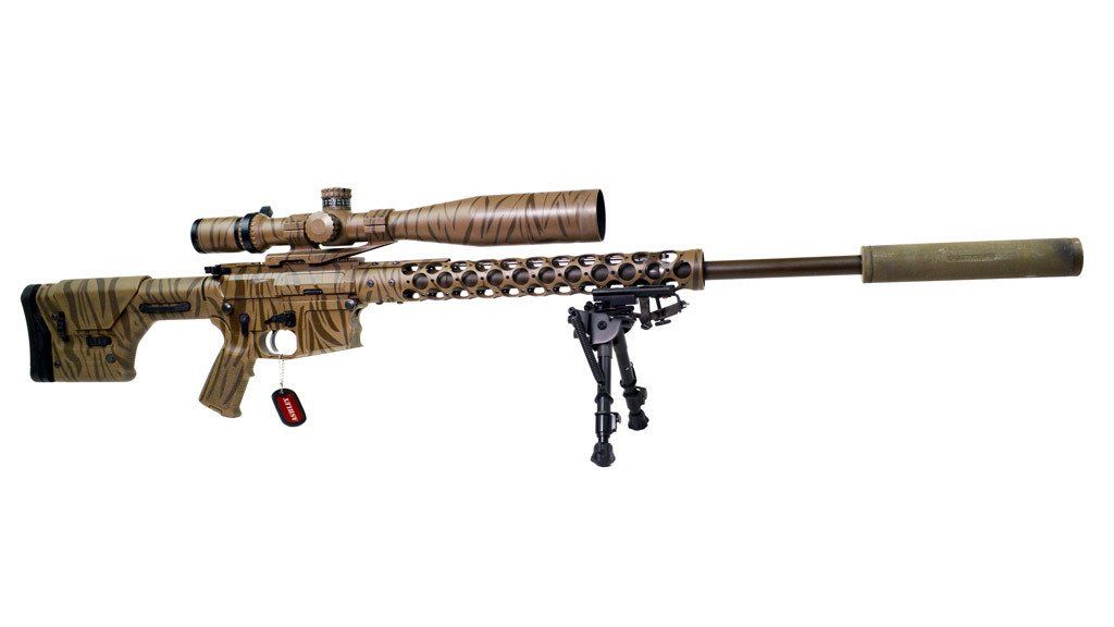 A camouflage rifle with a scope and bipod is on a white background.