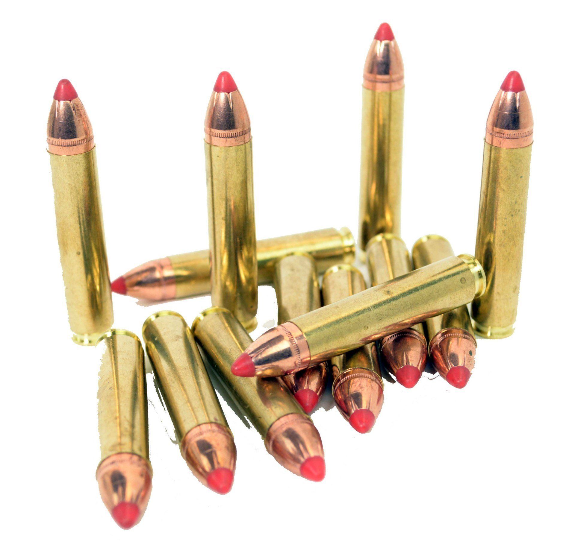 Group of rifle bullets, each with a brass casing and red tip, on a white background.