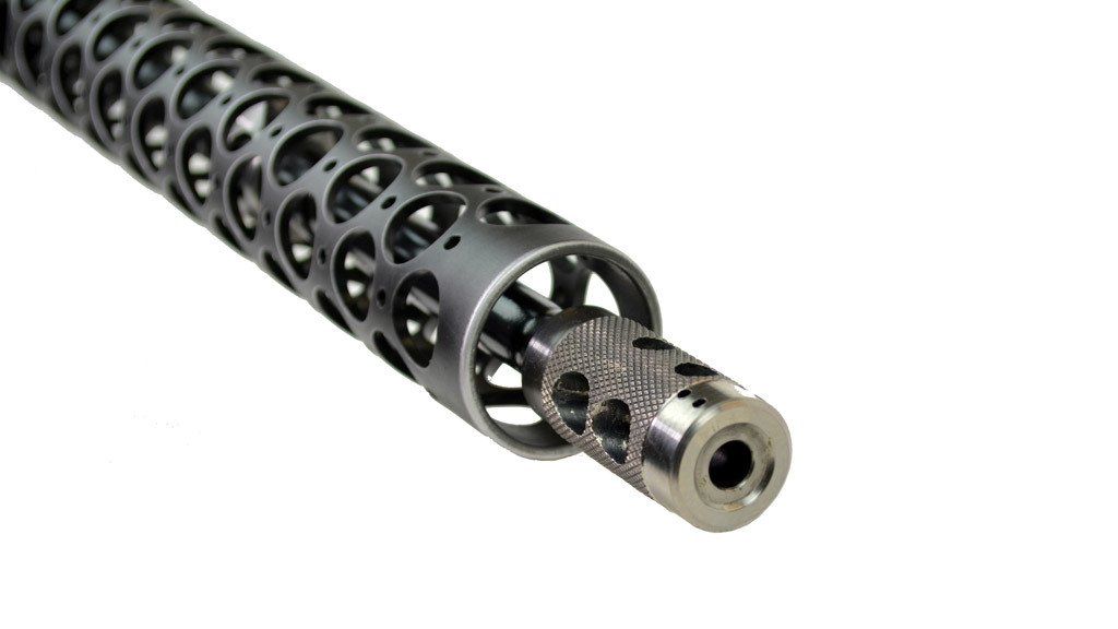 Perforated metal rifle barrel with muzzle brake.