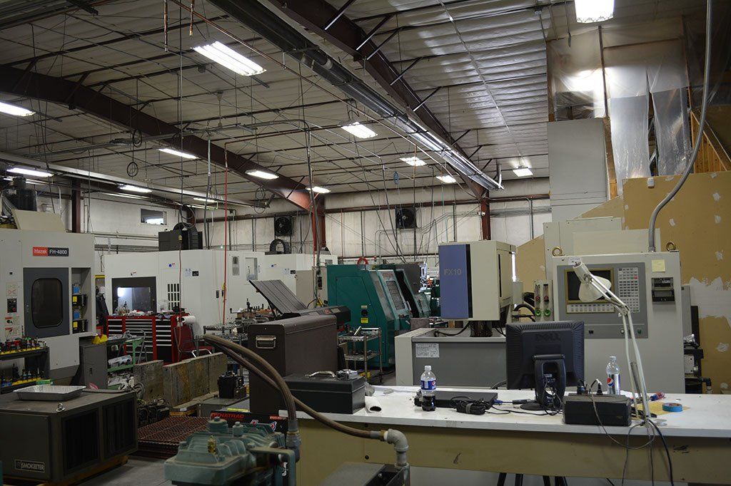Industrial workspace with machinery and a workbench.