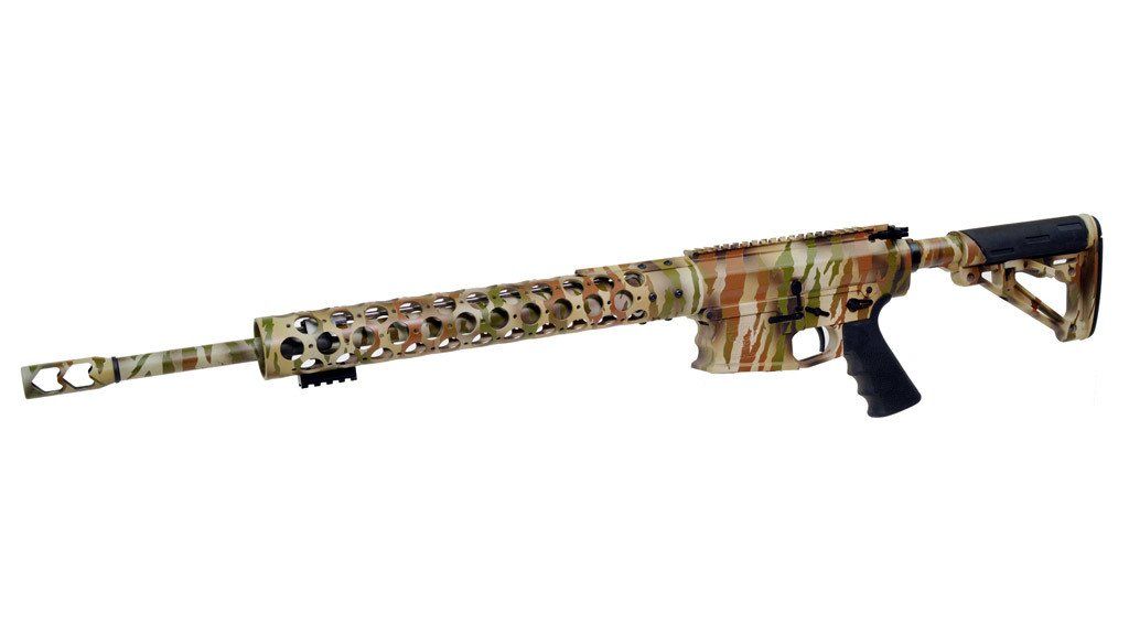 Camouflage rifle on a white background, featuring a long barrel and black grip.