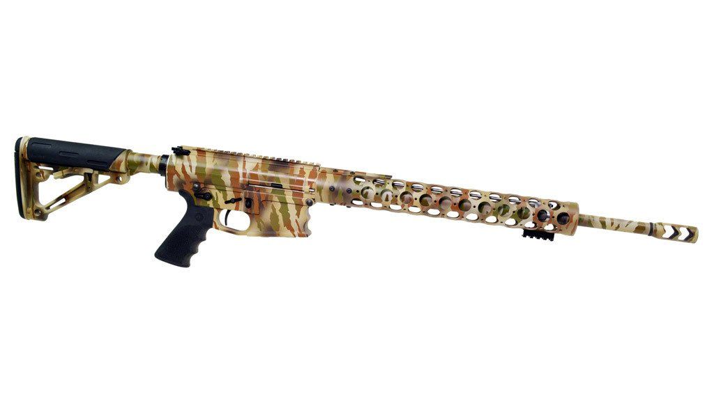 Camouflage-patterned rifle, right-facing, against a white background. It has a long barrel and grip.