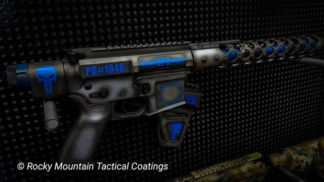 Customized AR-15 rifle with blue skull design, blue accents, and dark gray background.
