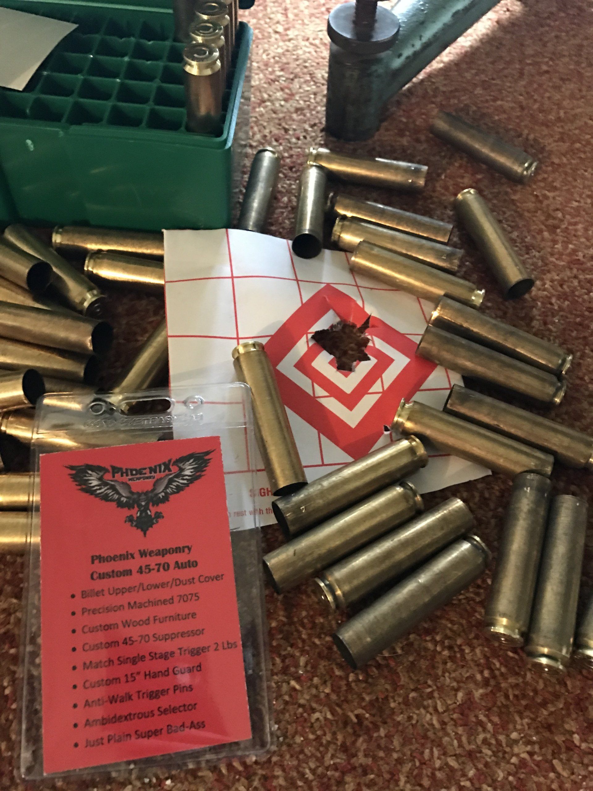 Brass shell casings scattered around a target with bullet holes and a reloading supplies list.